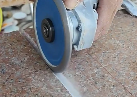 angle grinder saw blade cutting granite
